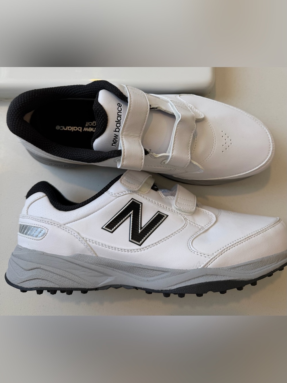 New Balance Men's White and Black Leather Strap Sneakers
